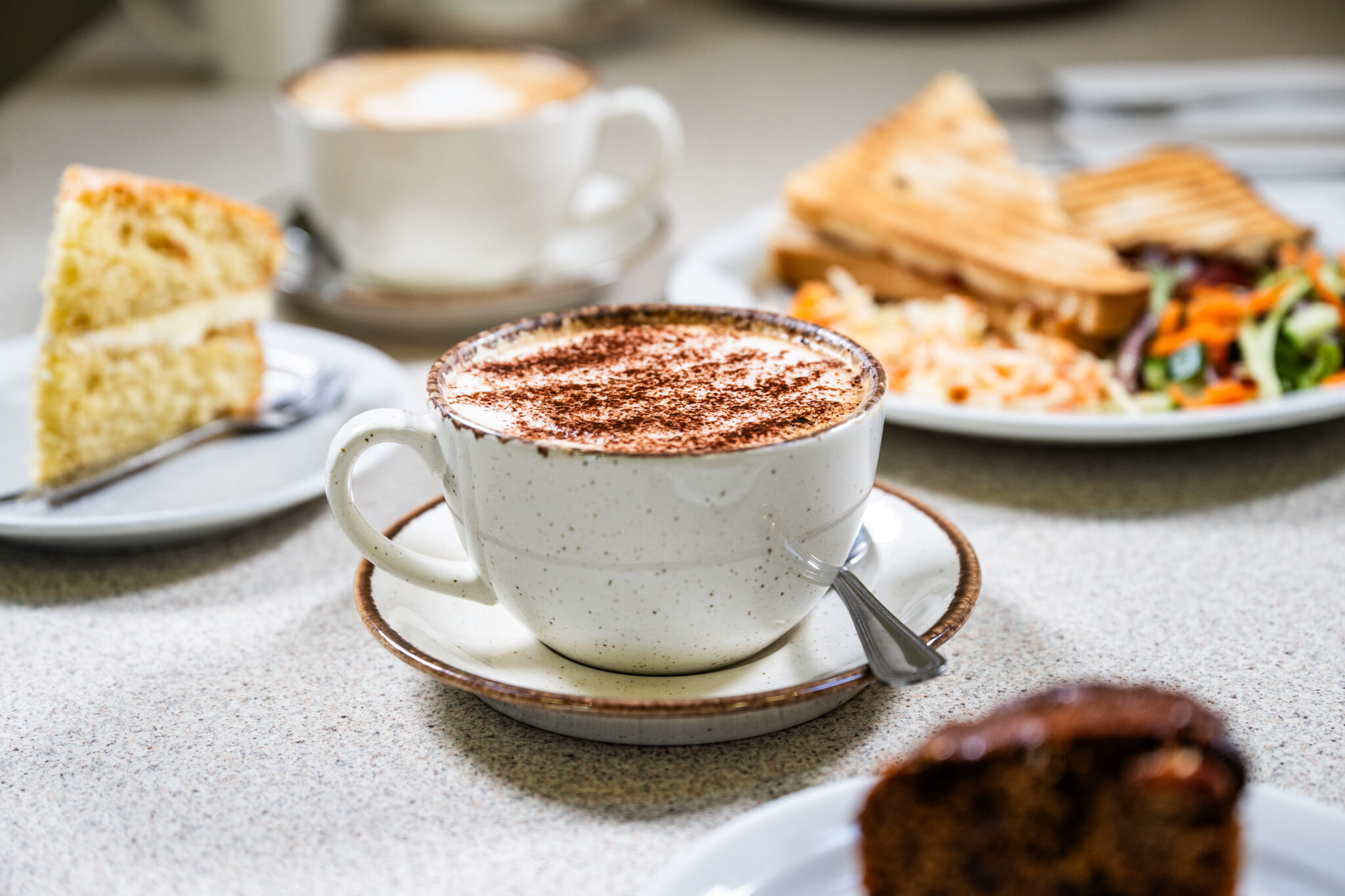 Photograph of cakes, hot drinks and sandwiches available in The Abbey Garden Cafe.
