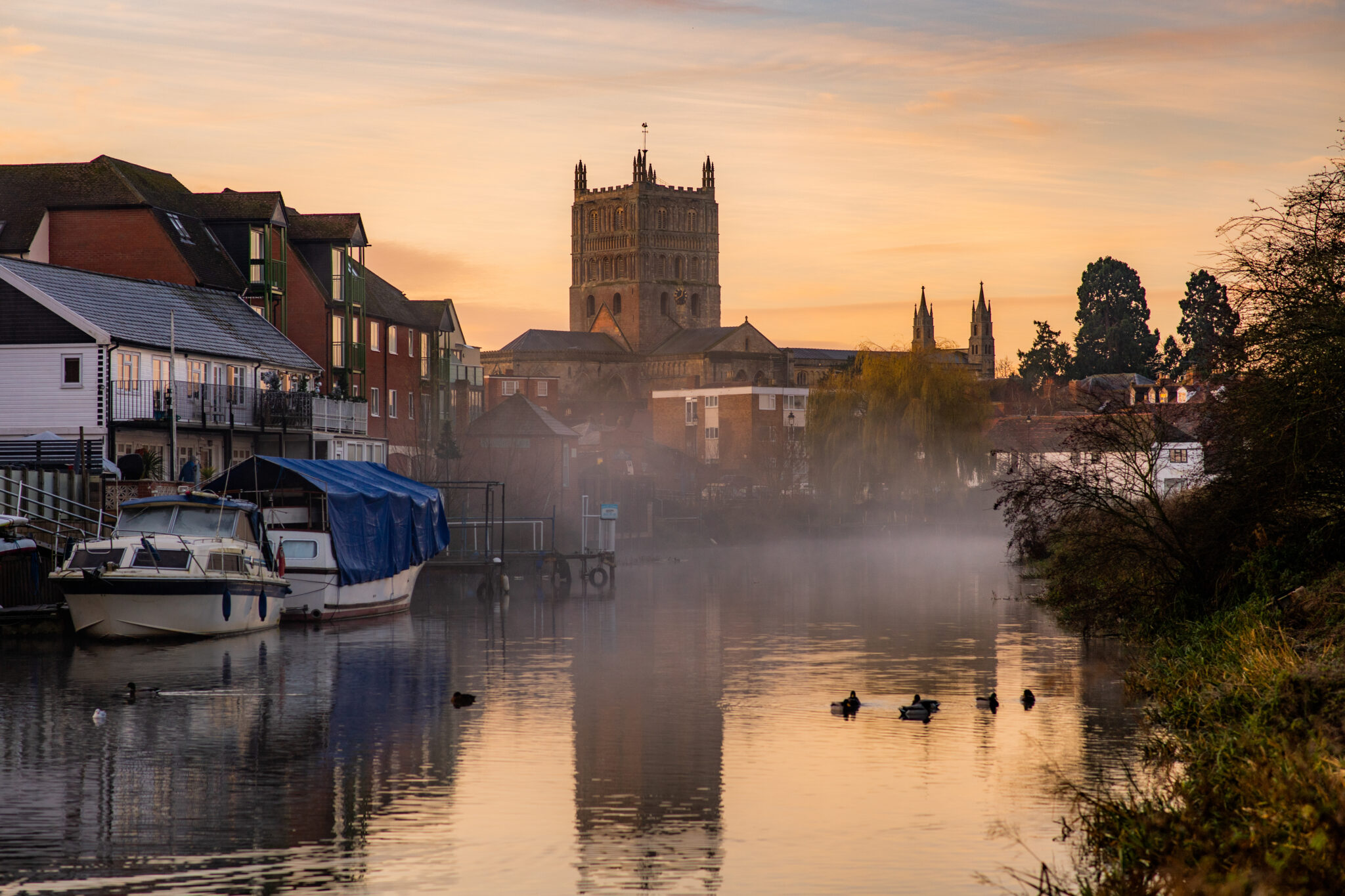 The morning mist rises around Tewkesbury Abbey.