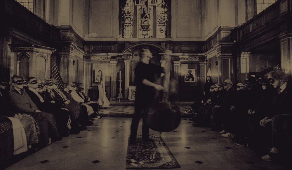 An faded out image of Tewkesbury Abbey Nave with the following text overlayed: The Christmas Orchestra Tewkesbury Monday 7 December Tewkesbury Abbey thechristmasorchestra,.co.uk